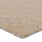 Side edge perspective focused on the fringeless border and natural fiber texture