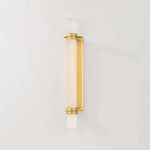 Groveland Station sconce illuminated showing warm light diffusion on white wall