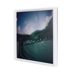 Side angle view highlighting the white frame thickness and depth around underwater wave photograph