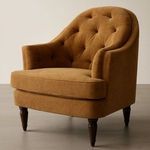 Styled Pandora Accent Chair in room setting showing wood flooring and soft warm lighting