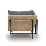 Back view revealing wood accent on woven frame beneath light gray cushions