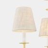 Amina Chandelier with aged brass finish, nine swept J-arms, white linen shades, and Victorian metalwork details