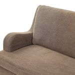 Close-up of curved armrest with linen upholstery and cushion edge detailing