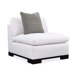 Three-quarter angle showing thick seat cushion and upright back cushions with textured gray pillow