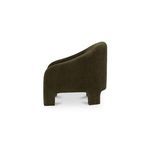 Side profile of Tuva Accent Chair highlighting its rounded back and low seat