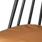 Close detail of leather cushion stitching and edge on black oak seat