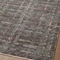 Close-up angled view of flatweave rug texture showing subtle color layering in plaid design