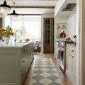 Runner size Francis Spa Granite Rug laid in a kitchen between cabinetry and stove under ceiling wood beams