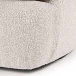Close-up on loose back cushion with visible stitching detail against rounded armrest