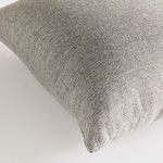 Close-up of woven neutral pattern and fabric texture on pillow corner