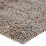 Close-up of rug corner showing texture-rich high-low pile and detailed muted multicolor patterns