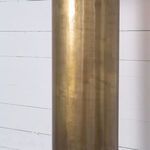 Close-up of upper antique brass portion of lamp base with subtle textured surface