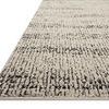 Rug shown from low angled side view highlighting flat, ribbed pile and thin edge binding