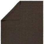 Top corner of rug turned over showing back side with reversed gray and brown striped texture