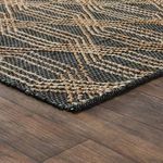 Low angled view of rug on wood floor highlighting thickness and braided pattern detail