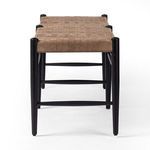 Wyatt Bench end view focusing on the vertical black legs and crossbars under woven leather seat