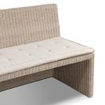 Side angled close-up showing rattan texture, seat cushion thickness, and bench curvature