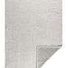 Full throw blanket with corner folded back to reveal sherpa lining beneath textured linen top