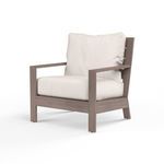 Laguna Club Chair outdoor accent chair in weathered driftwood finish with white plush cushions and plank arms.