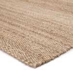Close-up of coarse woven texture showcasing natural tan fibers and subtle color variations