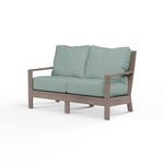 Laguna Loveseat in outdoor sofa style with hand-brushed aluminum frame mimicking driftwood and light blue cushions