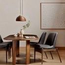Square dining table variation with darker caramel Guanacaste wood in a styled room with chairs and pendant light.