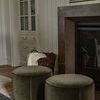 Ivory Vancouver Oversized Throw casually placed in woven basket beside fireplace in cozy living room