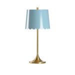 Brass table lamp with slender stem and scalloped blue tole shade with gold interior