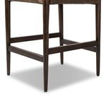 Close-up of tapered wooden legs and stretchers supporting Jayla counter stool