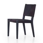 Dark tone variant of Villa Dining Chair displaying angled side profile with black hair on hide