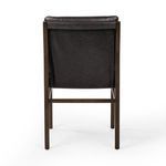 Close-up of leather back cushion with subtle grain and oak frame rear support