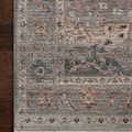 Detailed view of rug’s fibers and floral pattern on wood floor background