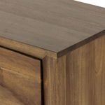 Close-up on chamfered edge at dresser top showing smooth wood surface