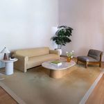 Living room scene showing Pierce Accent Chair paired with sofa, marble coffee table, and indoor plant