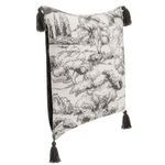 Angled side view highlighting pillow’s painted toile front and dark solid velvet back with tassels at corners