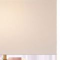 Close-up of cream rectangular fabric lamp shade texture and brass frame top detail