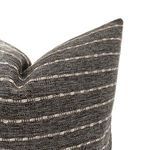 Close-up angled view showing detailed woven texture and subtle stripe pattern of charcoal pillow fabric
