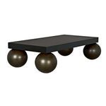Back view focusing on the aged brass spheres supporting the coffee table's black top