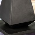 Close-up of the graphite finish texture on the angular cast aluminum base of the Janil Accent Table