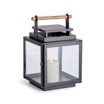 Adwin Outdoor Lantern with black square metal frame, wide glass panes, and teak wood handle, candle inside