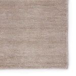 Zoomed-in view of light taupe rug surface showing soft, even weave and color variation