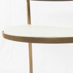 Close-up of smooth white marble top shelf edge with brass frame detail
