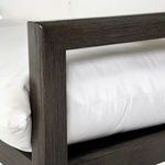Close-up of dark slate gray aluminum sofa frame arm corner with white cushion