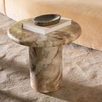 Frida Outdoor Side Table placed on carpet with book and decorative dish on top