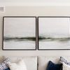 Two Gray Essence II paintings side by side above sofa with patterned and solid blue pillows in living room