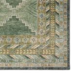 Top-down close detail of rug corner highlighting floral border and layered geometric motifs