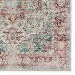 Zoomed-in detail of the rug's bottom border showcasing floral medallion and intricate pattern