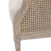 Close-up highlighting the carved front leg and curled arm scroll detail on rattan cane frame