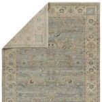Partial fold back of rug corner displaying reverse side texture and weave