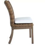Side profile view of Montecito chair showing curved woven backrest and cushion thickness